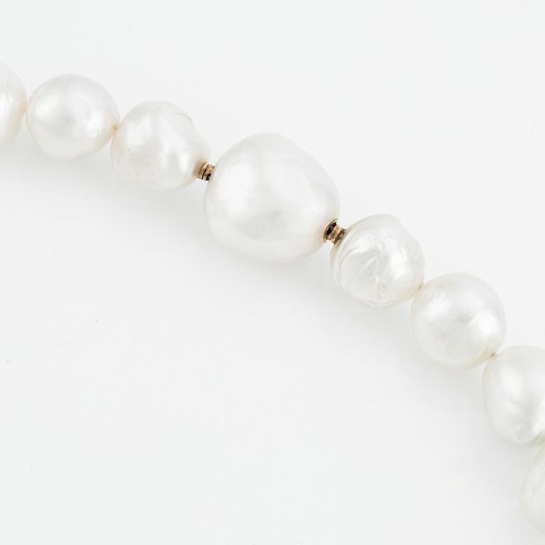 A Gaudy necklace with cultured South Sea pearls, a platinum bracelet, and two clasps.