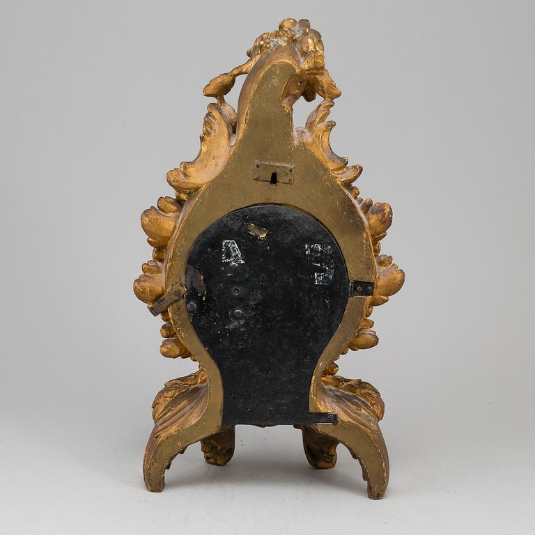 A swedish rococo gilt wood mantle clock.