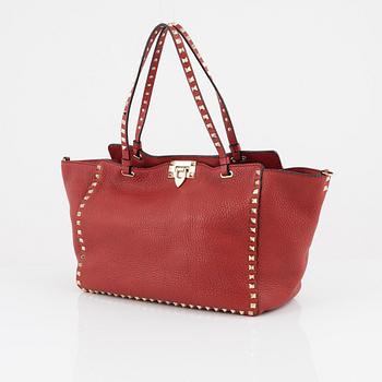 Valentino Gravani, a red leather studded tote bag, 2018.