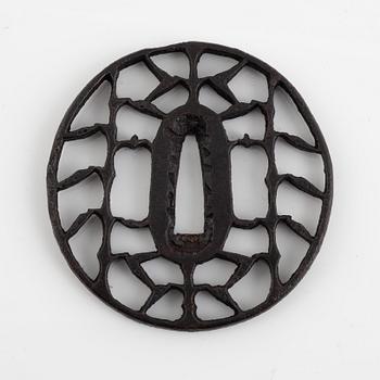 An iron open work, sukashi, Japanese tsuba, Edo (1603-1868). In a kiri box.
