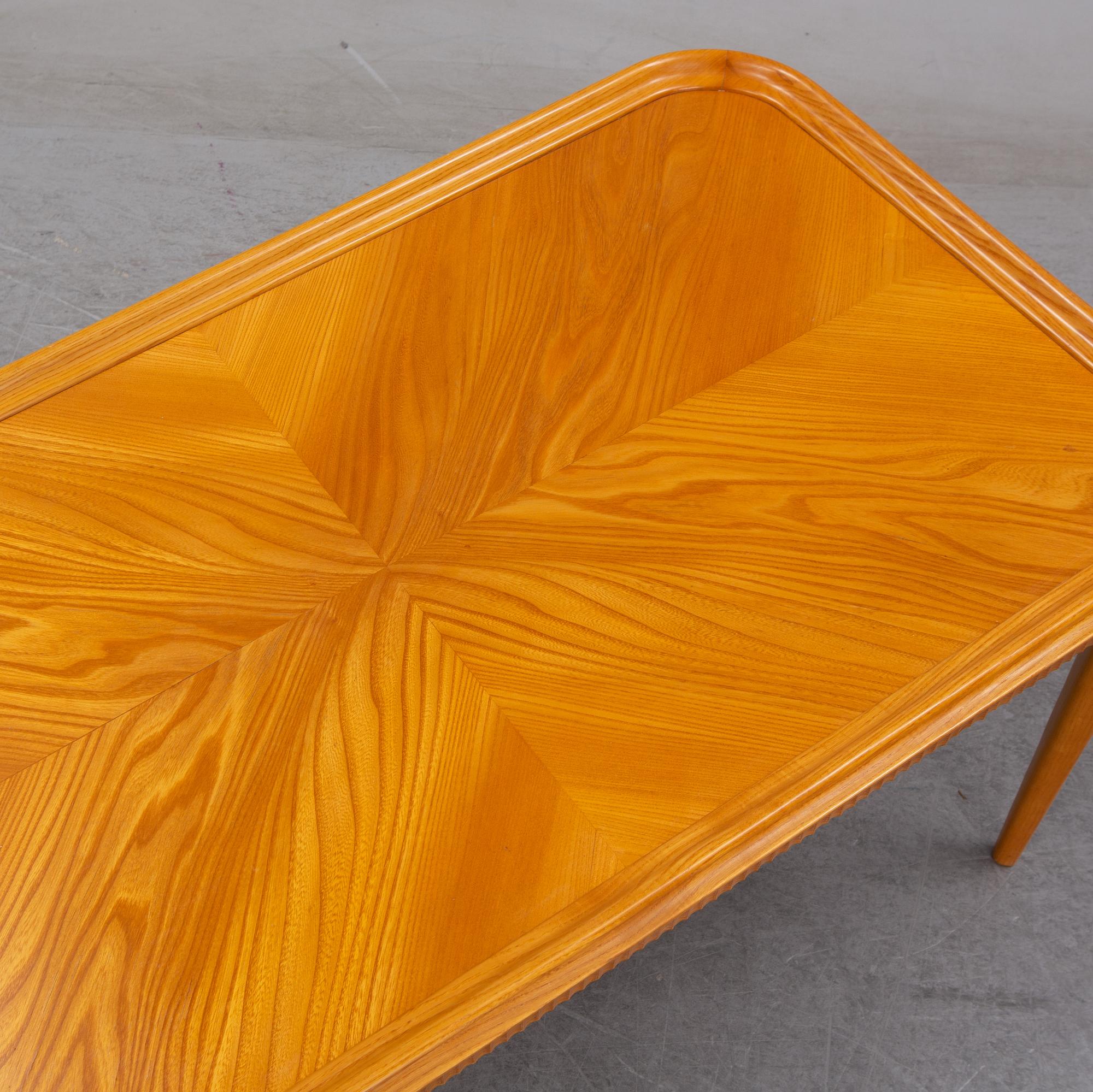 An elm Swedish Modern coffee table, dated 11 11 1947.