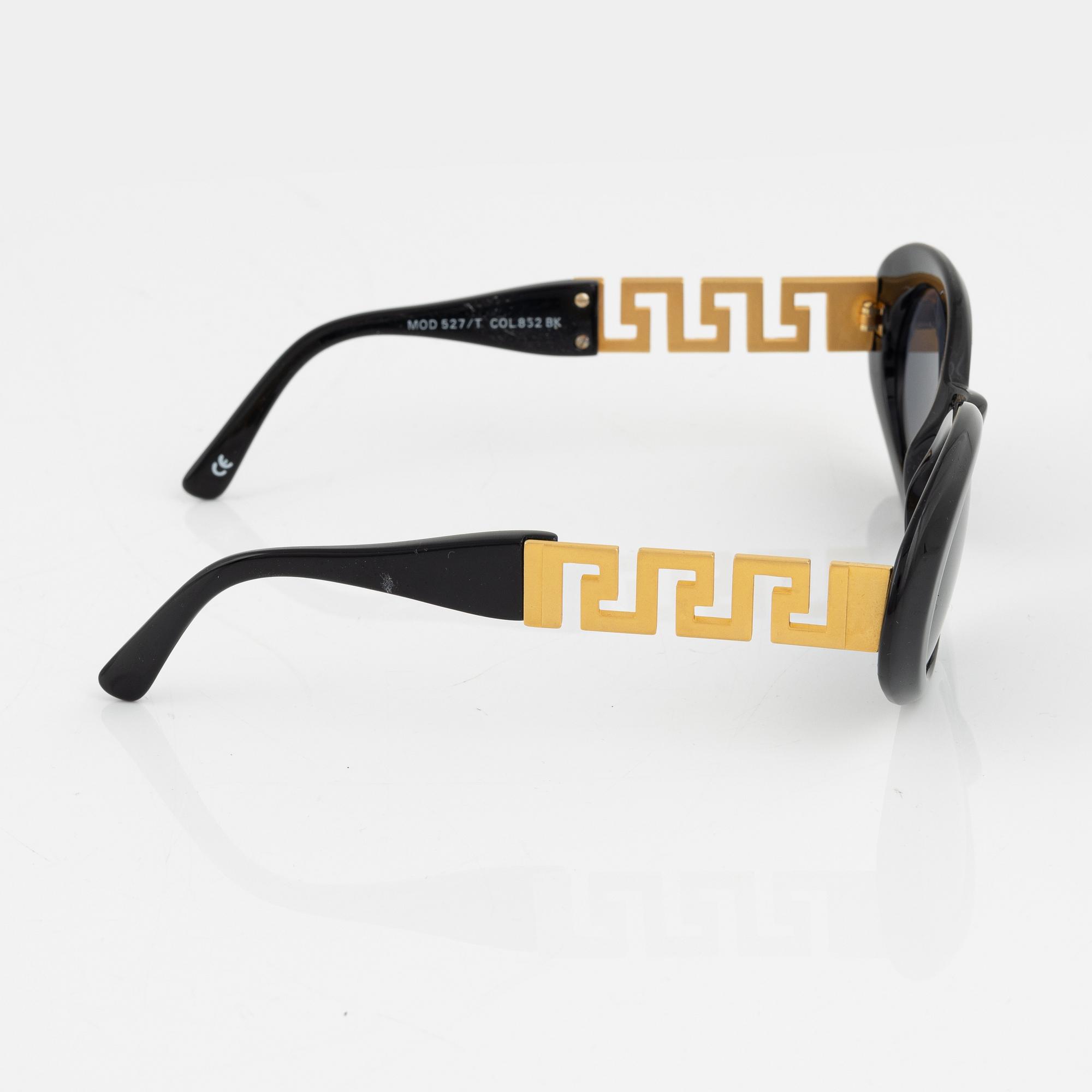 Gianni Versace, a pair of black and gold sunglasses.