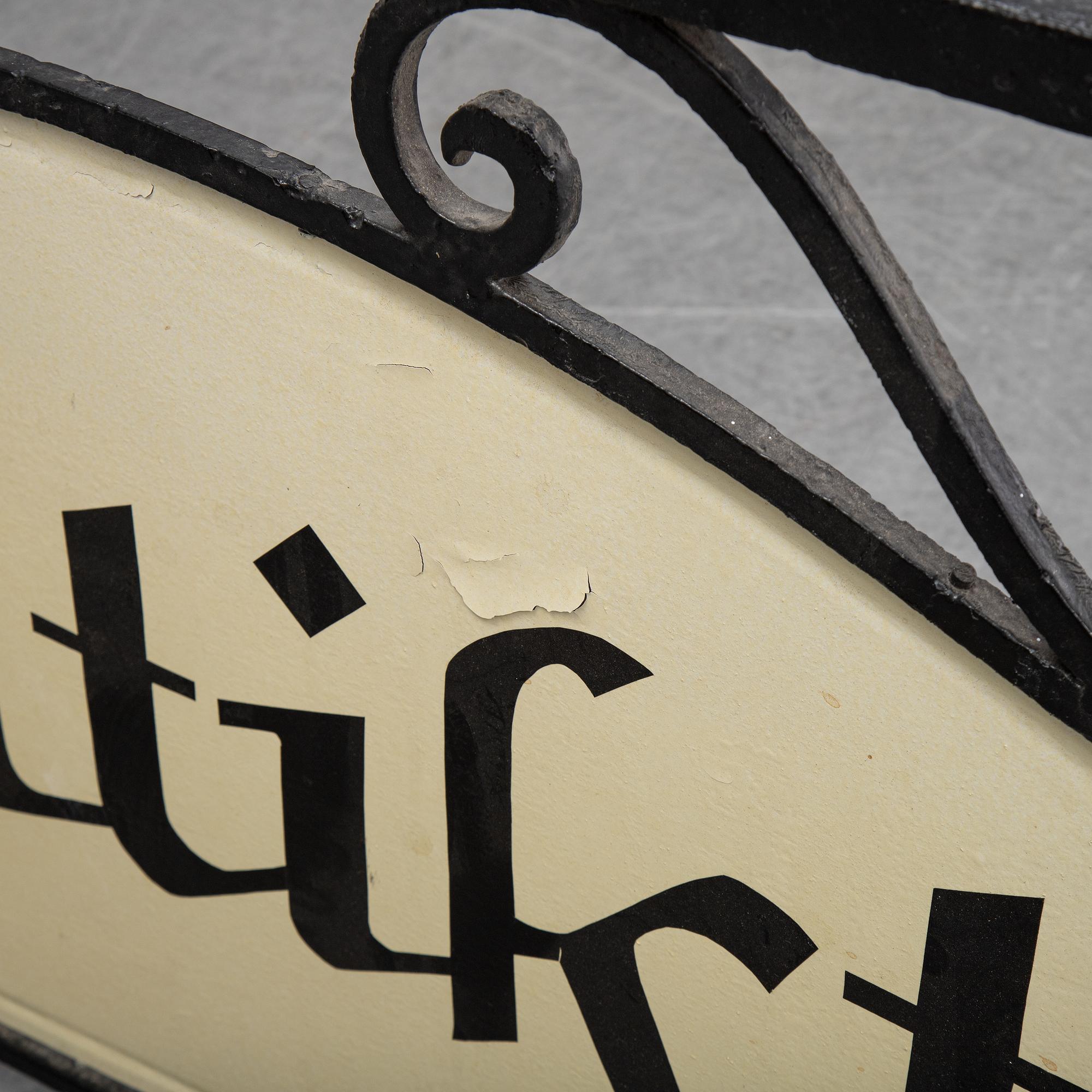 A wrought iron shop sign, 20th Century.