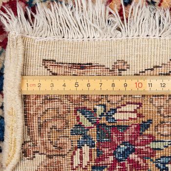 A pair of similar Kirman rugs, south Persia, c. 147 x 94 and 154 x 96 cm.