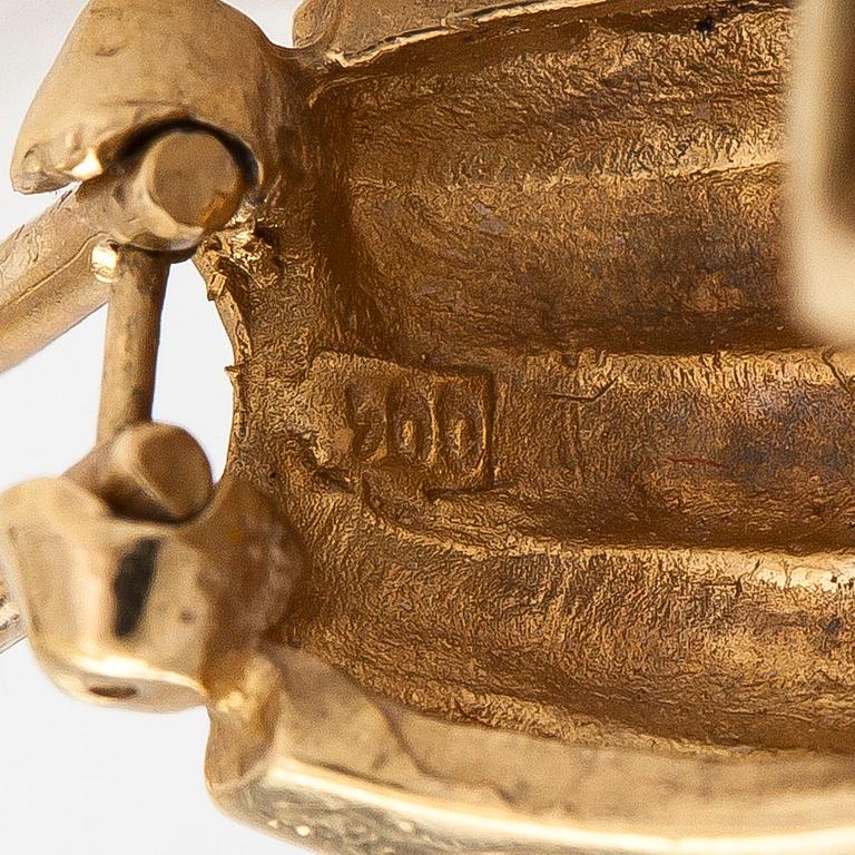 A pair of 18K gold earrings set with small diamonds.