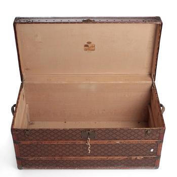 AUX ETATS UNIS, a Monogram canvas trunk, early 20th century.