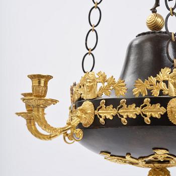 A patinated and ormolu six-light Empire chandelier, Stockholm, first part 19th century.
