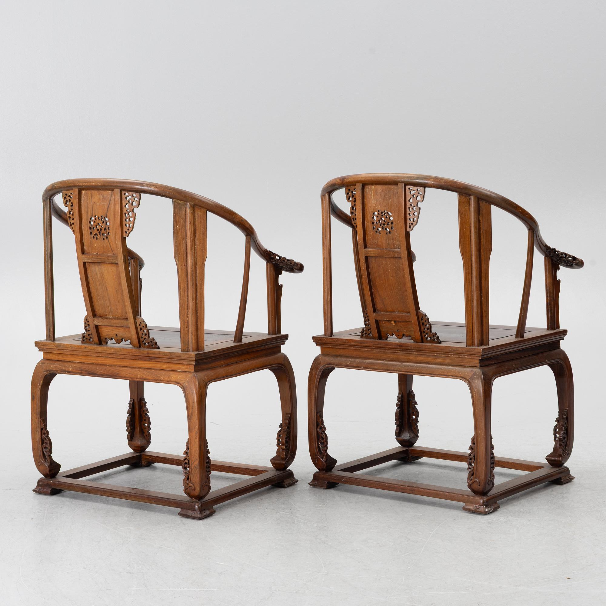 A pair of Chinese horseshoe-back hardwood armchairs, 1900s.