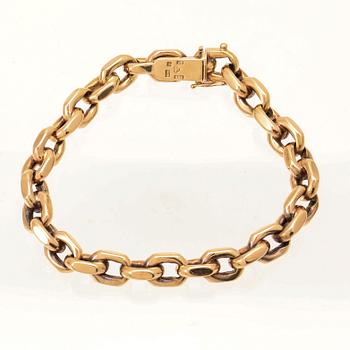An 18K gold anchor link bracelet.