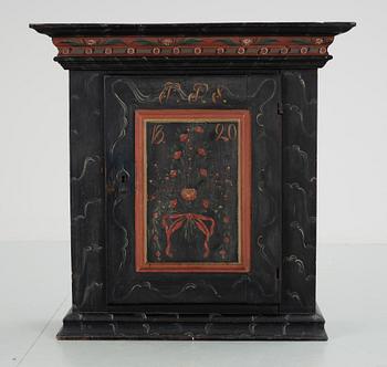 A Swedish wall cabinet, dated 1820.