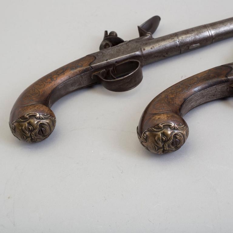 A pair of Queen Anne flintlock pistols makers mark Barker and London proof marks.