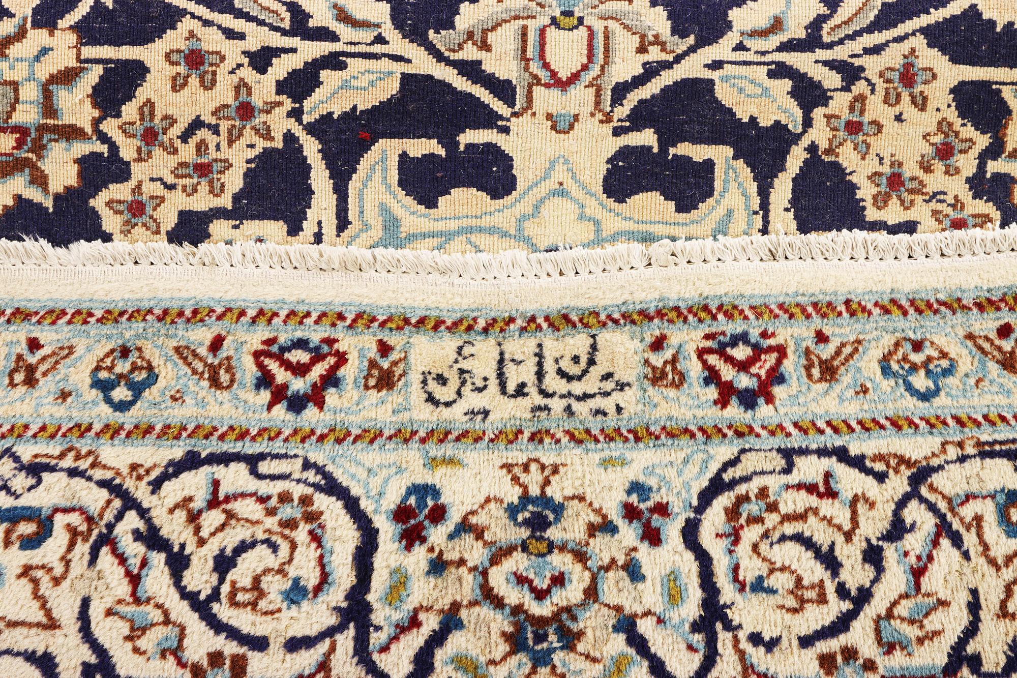 A Nain carpet, part silk, c. 338 x 244 cm.