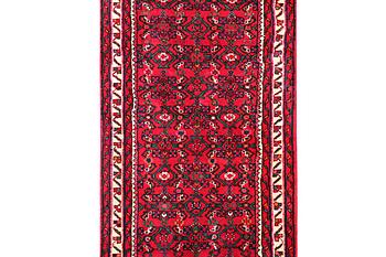 An oriental runner carpet, c. 395 x 87 cm.