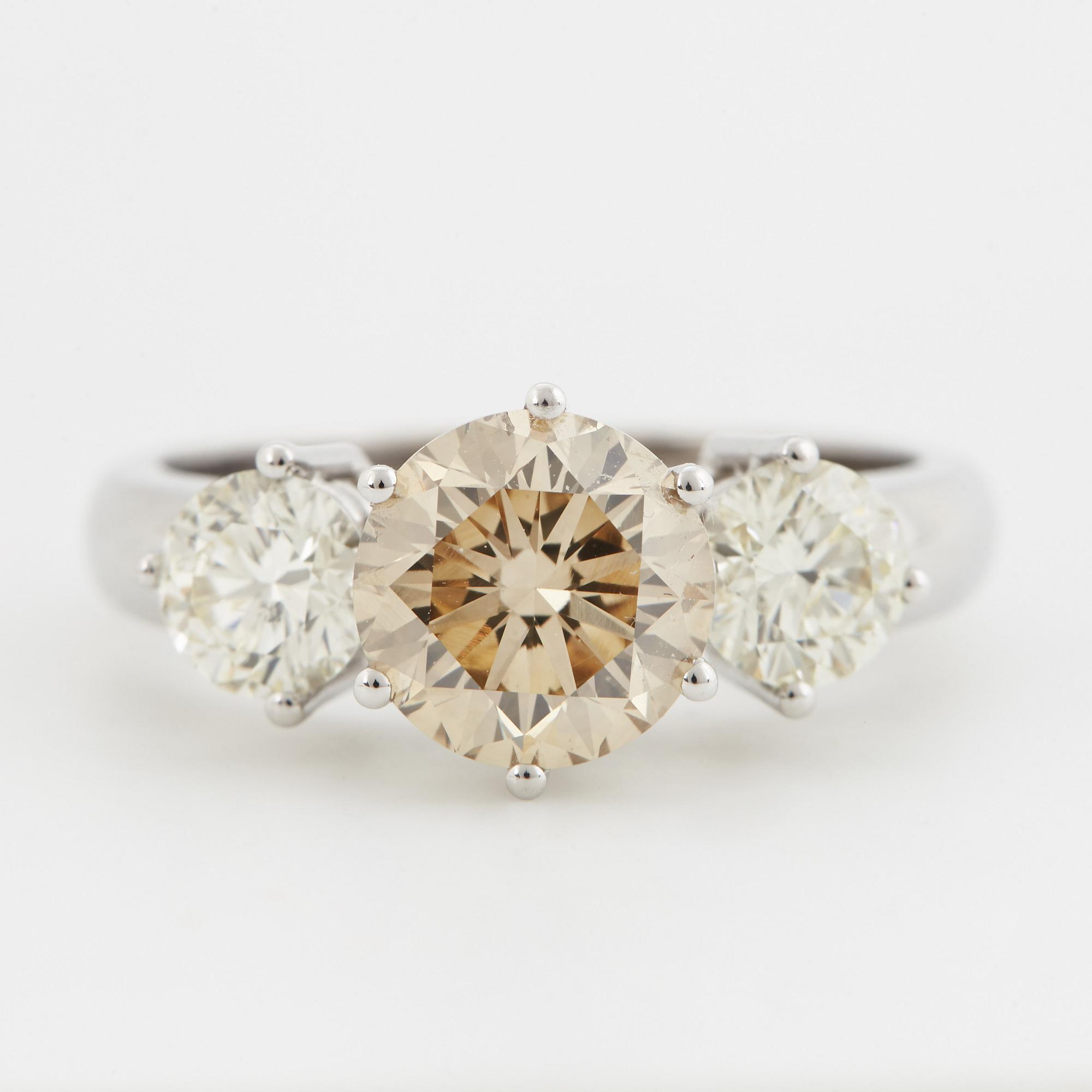 Fancy light yellowish brown round brilliant-cut diamond ring.