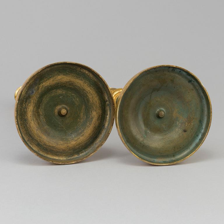 A pair of French Directoire late 18th century ormolu candelabra for three candles.