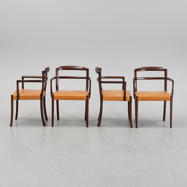 A set of four black stained beech tree arm chairs with leather upholstery, second half of the 20th century.