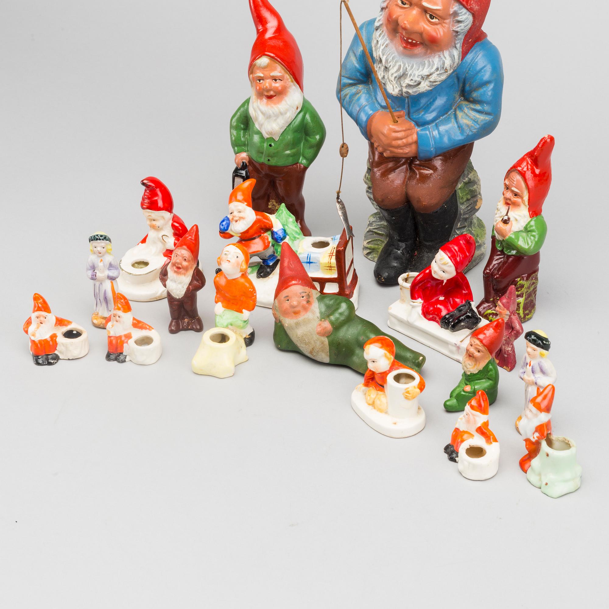 18 porcelain and pottery figurines and candleholders. First half of the 20th cetnury.