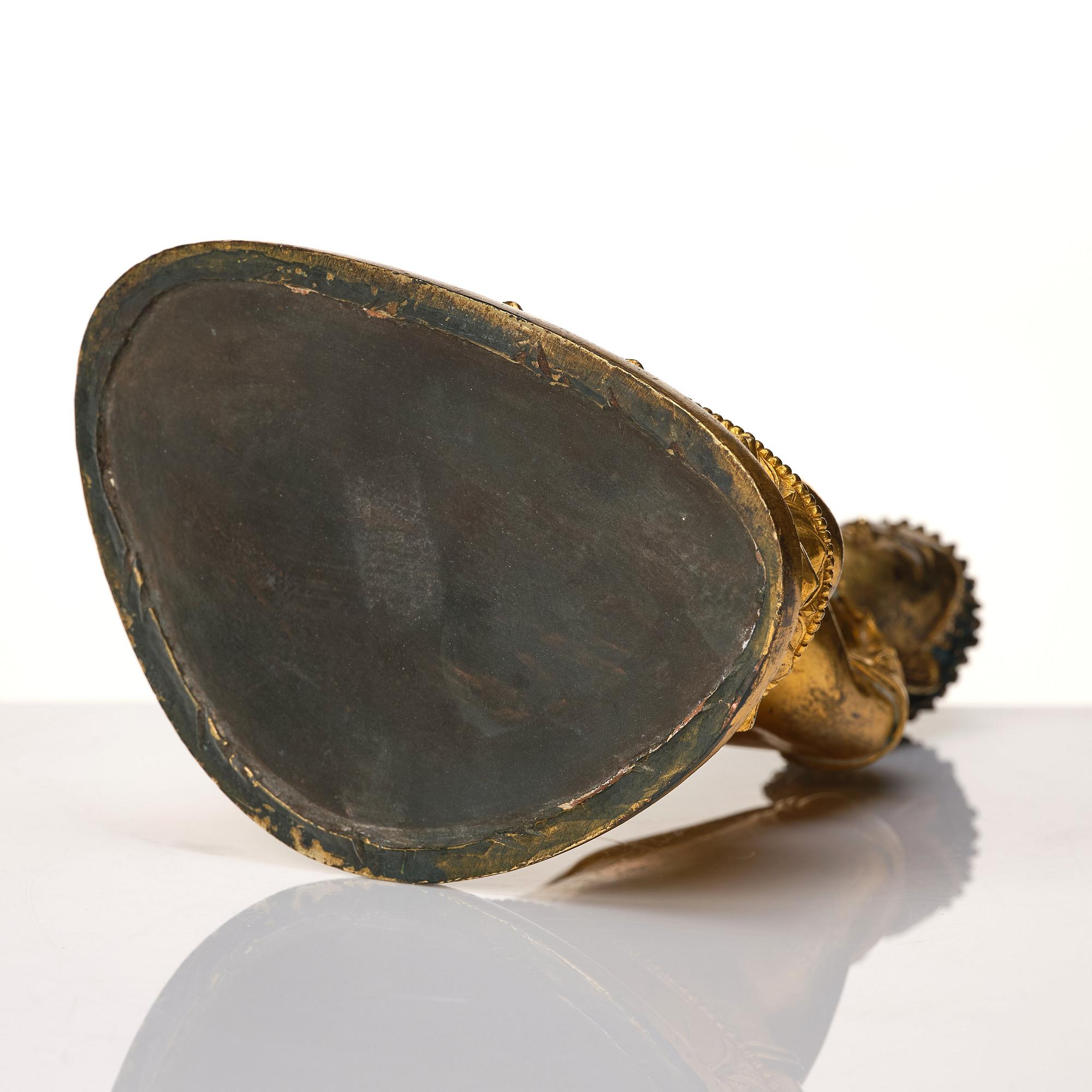 A Tibeto Chinese style gilt copper alloy figure of Buddha.