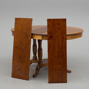 A first half of the 20th century dining table veneered with birch. With three extension leaves.