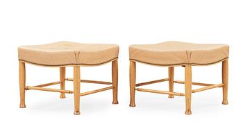 A pair of Josef Frank mahogany and beige leather stools, Svenskt Tenn, model 902.