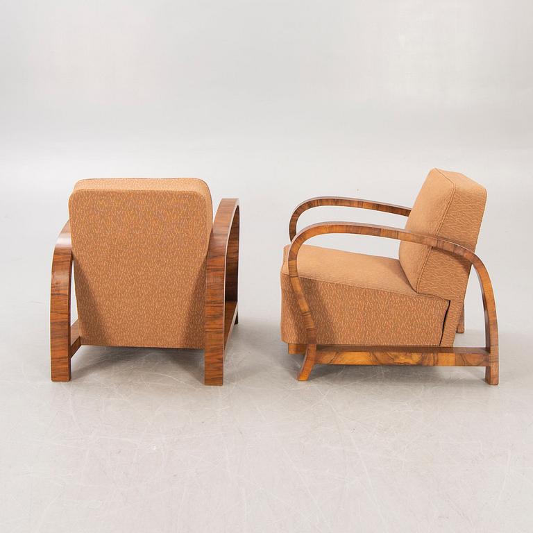A pair of Art Deco walnut armchairs.