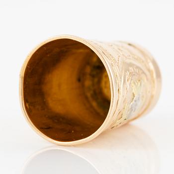 An 18K gold and carnelian thimble.