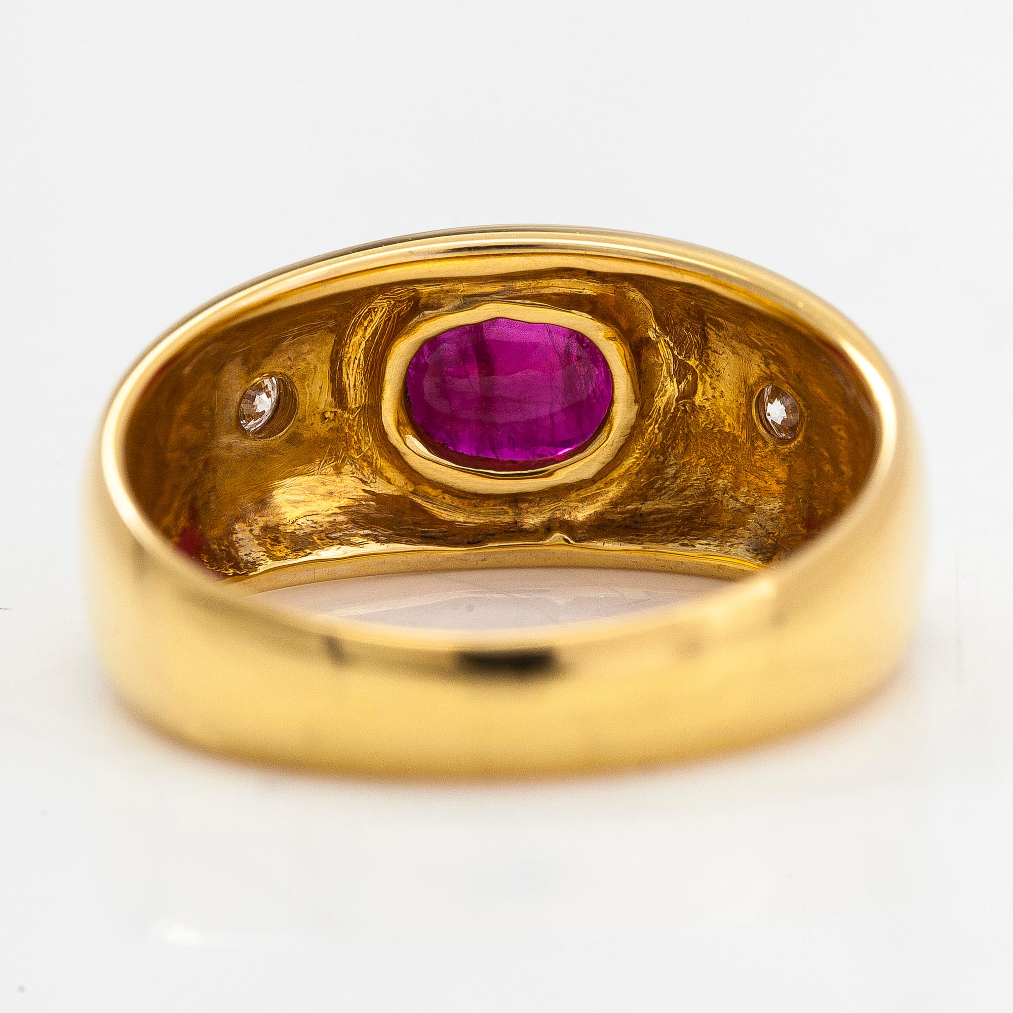 A 14K gold ring, set with an oval-cut ruby and diamonds totaling approx. 0.06 ct. Finland, 1999.
