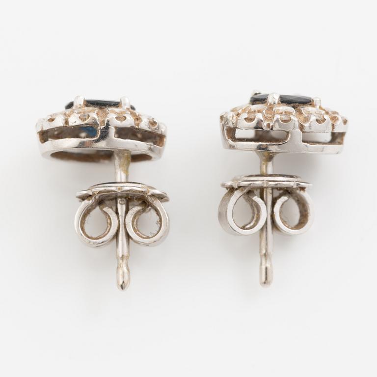 Earrings, a pair of 18K white gold set with dark sapphires and small brilliant-cut diamonds.