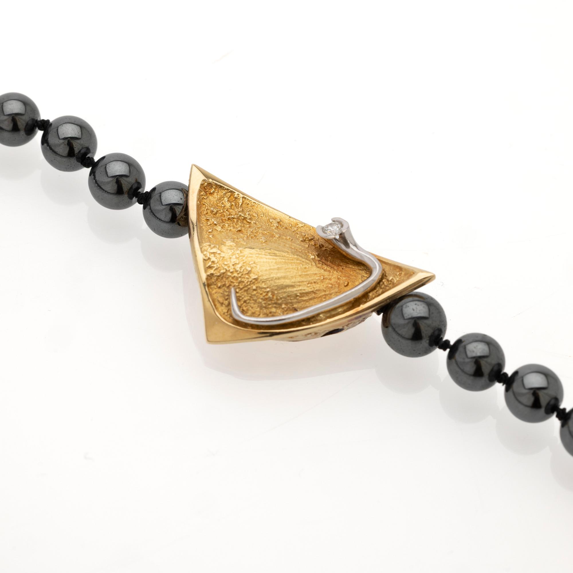 Ole Lynggaard, Hematite necklace with an 18K gold clasp and a diamond.
