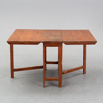 A pine gate leg table, 19th Century.