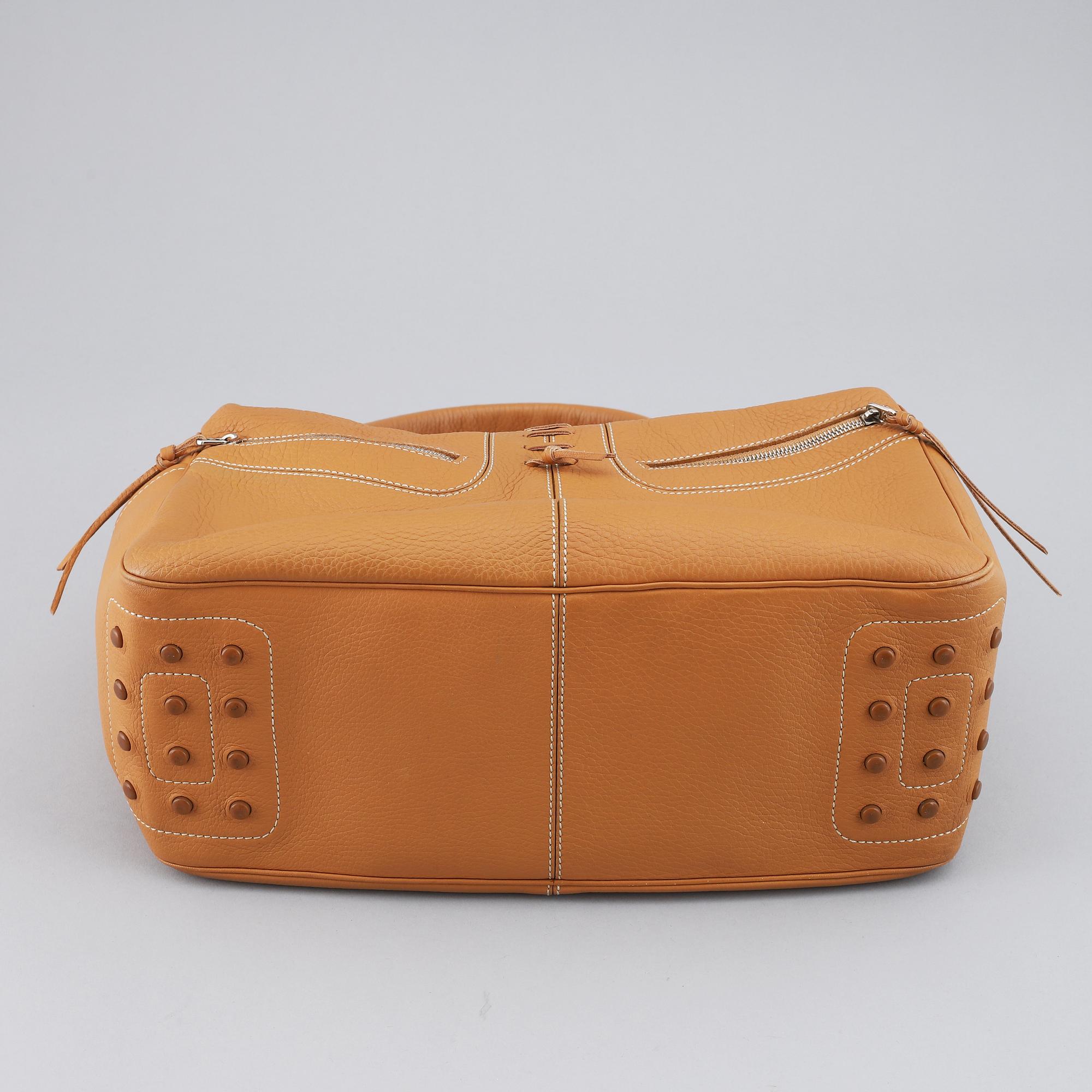 TOD'S, a tan leather bag.