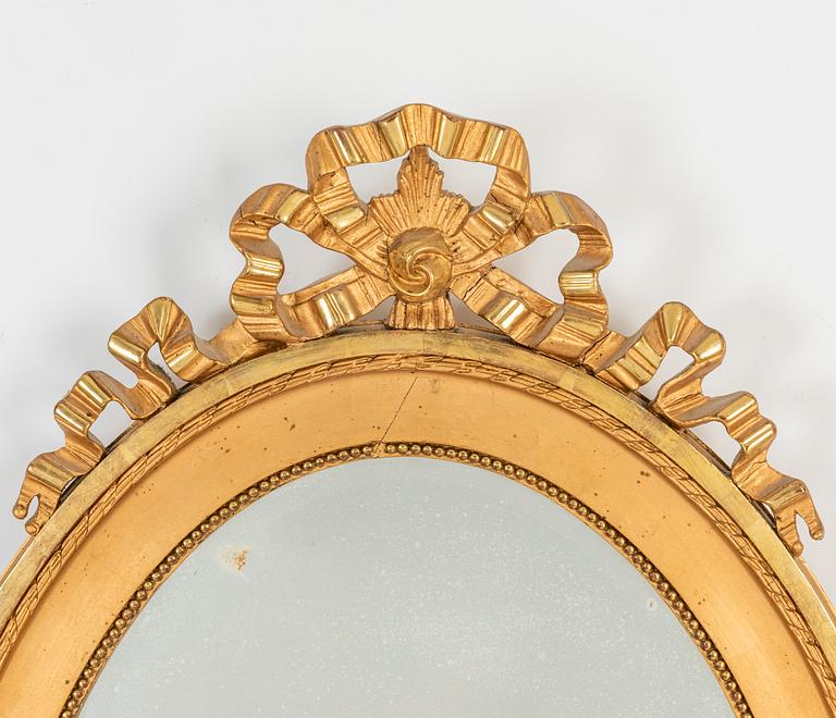 An oval Gustavian style mirror, early 20th Century.