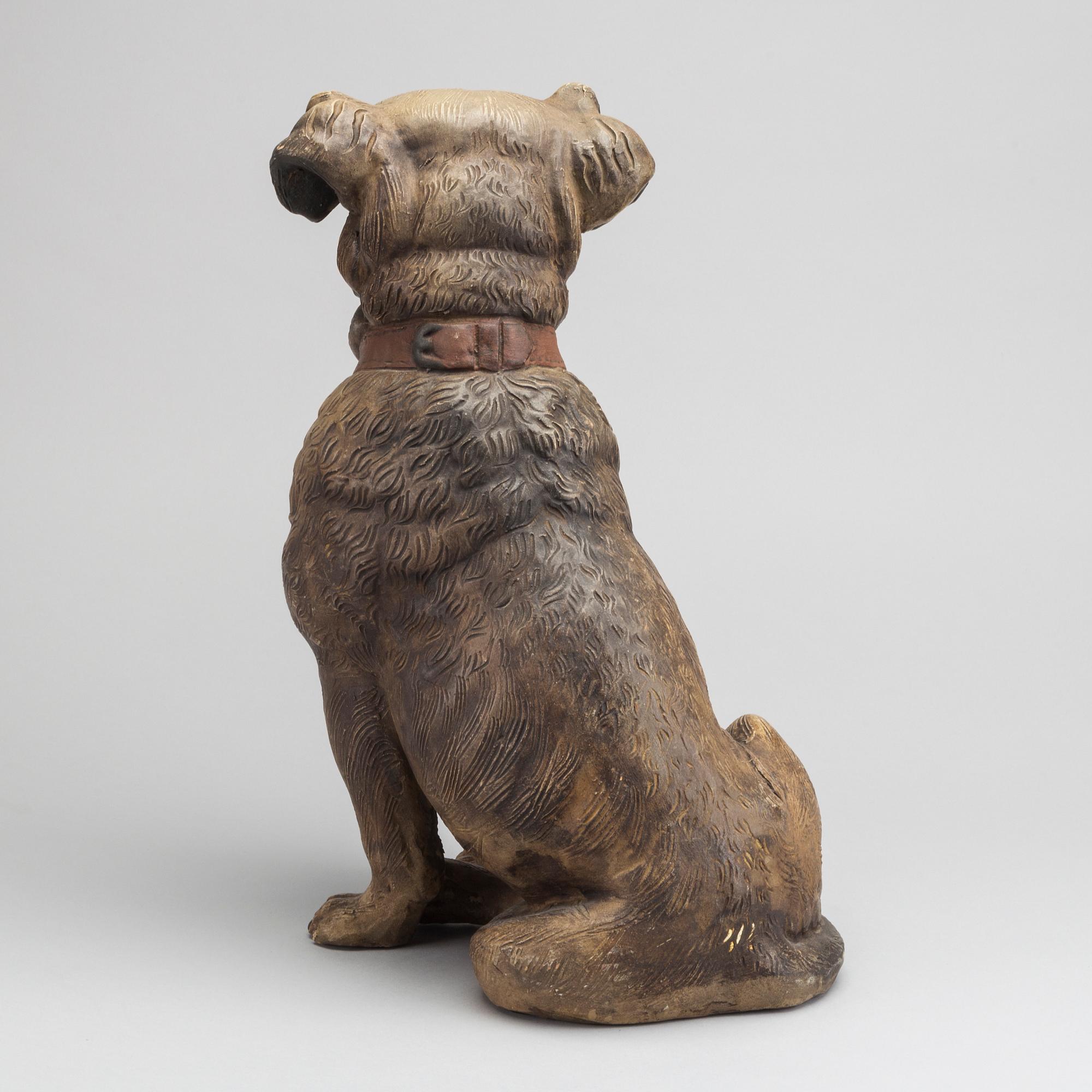 A 20th CENTURY TERRACOTTA DOG.