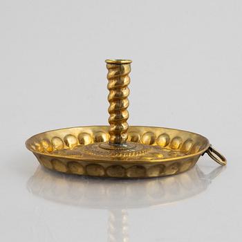 A Swedish repoussé brass reflector / candlestick.