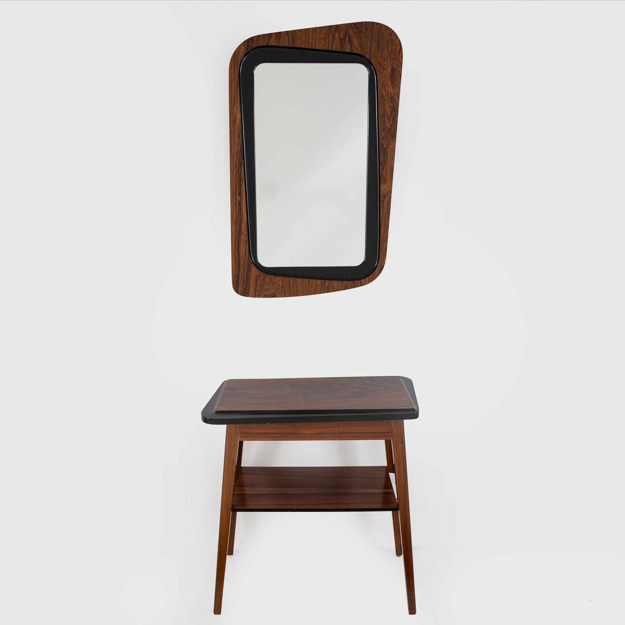 A second half of the 20th century rosewood mirror with table.