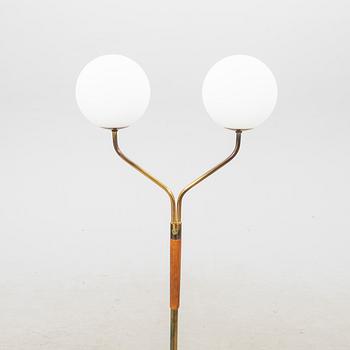 A mid 20th century teak and brass floor lamp.