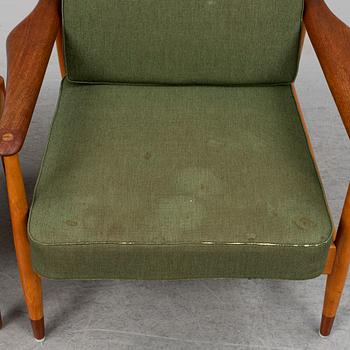 A 1950's beech and teak model FD 161 easy chair with stool by Arne Vodder for France & Son.