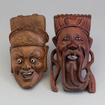 Two wooden south east asian masks, 20th century.
