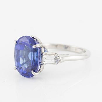 Ring, Fred Leighton platinum with an oval faceted tanzanite and fancy-cut diamonds.