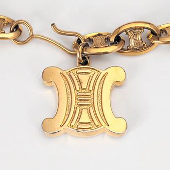 CÉLINE, a chain belt.