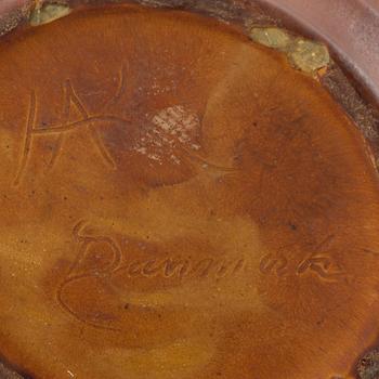 An earthenware pot decorated with four bulls heads. Probably by Karl Hansen Reistrup for Herman Kähler. Around 1900.