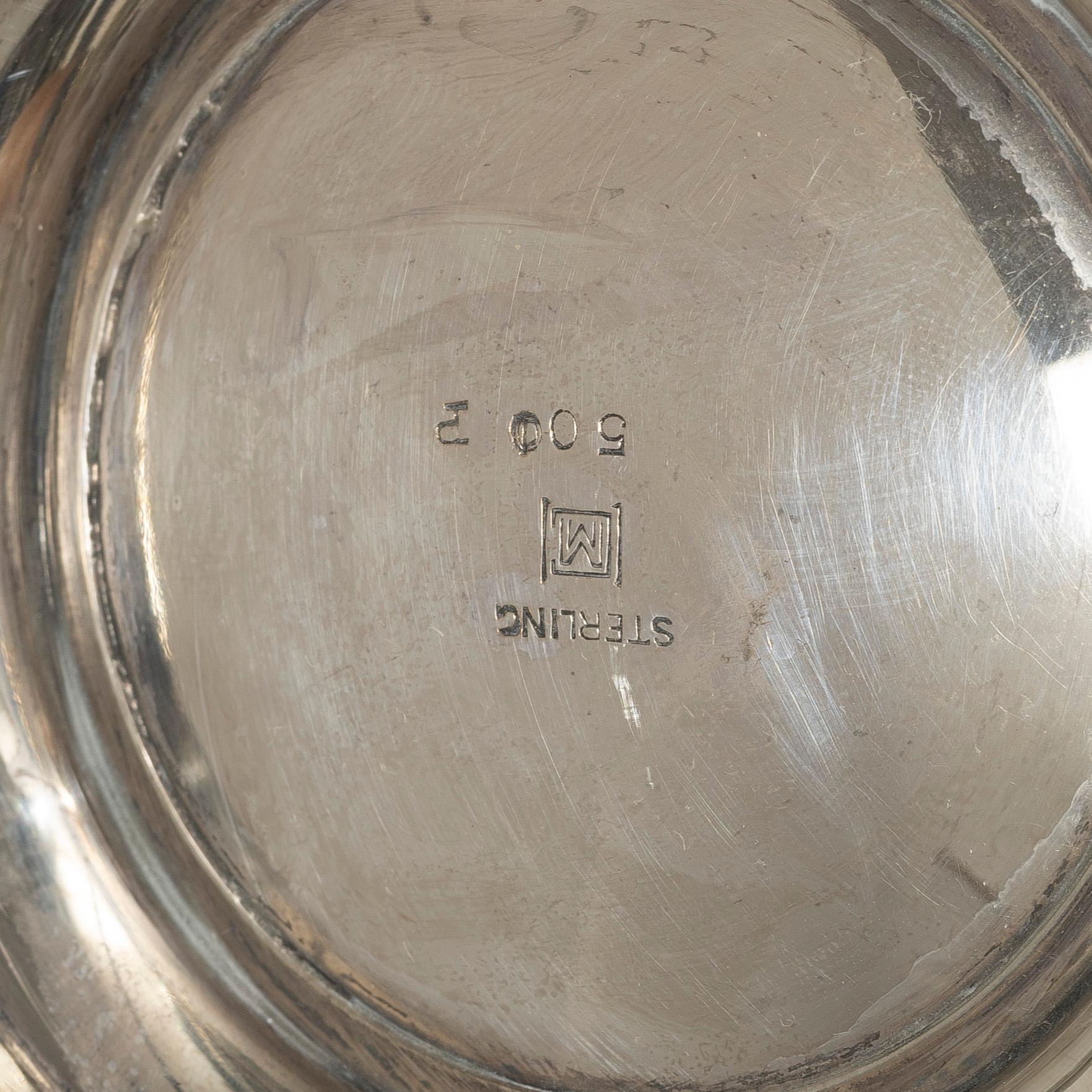 A sterling silver bowl with handle, signed with monogram CMM, 20th century.