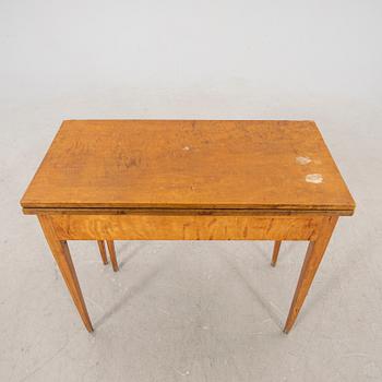 An earluy 1900s birch game table.