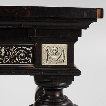A Renaissance-style ebony, ebonized and ivory-inlaid library table, late 19th century, presumably Germany.
