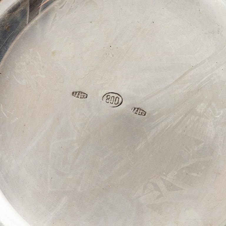 Three Silver Shakers and a Beaker.