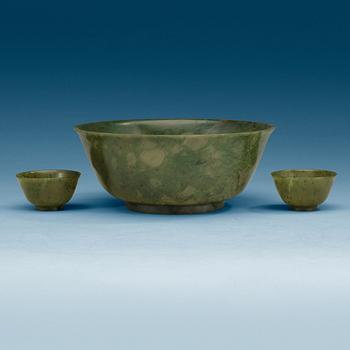 1639. A Chinese green stone bowl and two winecups.
