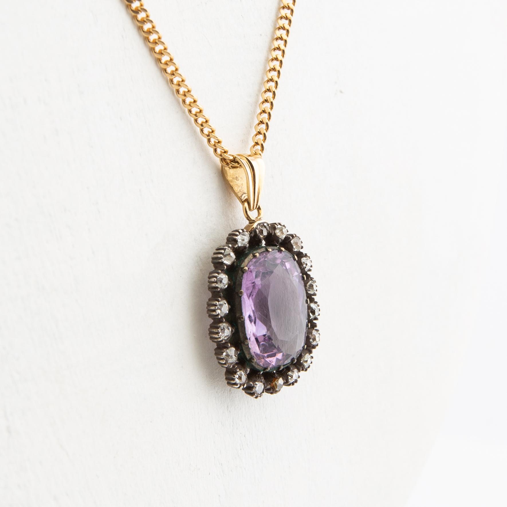 Pendant, 18k gold with diamonds and purple stone.