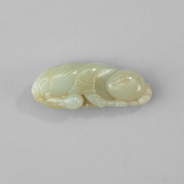 A Chinese nephrite figure of reclining boy.