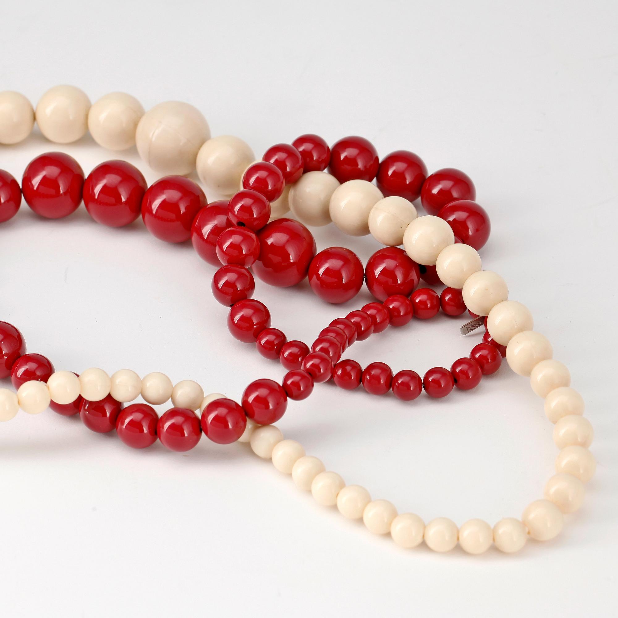 YVES SAINT LAURENT, two beaded necklaces.