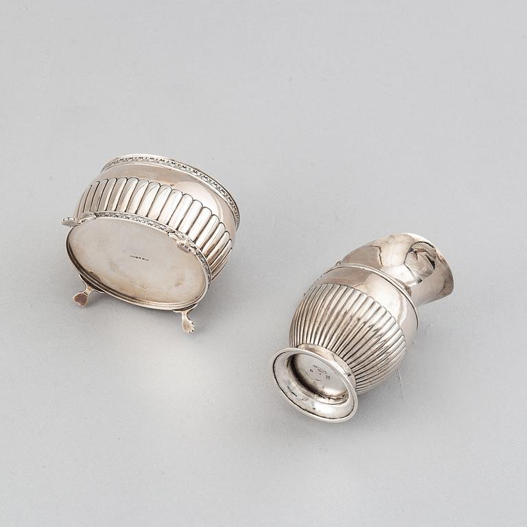 A silver creamer by Johan Petter Ahlforss, Strängnäs, 1833 and a silver sugar box, Kristianstad, 1928.